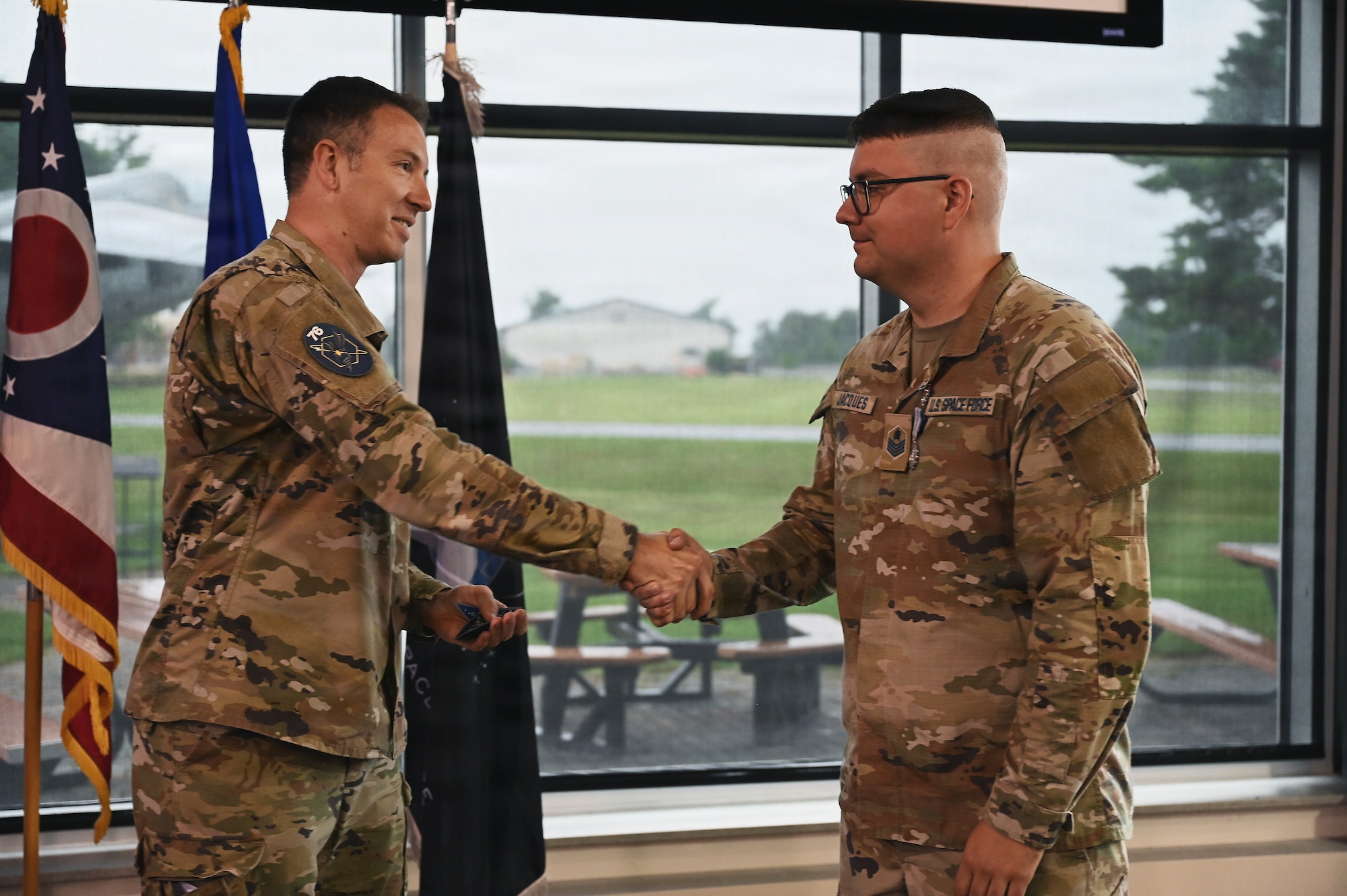 U.S. Space Force Lt. Col. Stefan Katz, commander of the 76th Intelligence, Surveillance and Reconnaissance Squadron welcomes Air Force Tech. Sgt. Dylan Jacques, an intelligence analyst assigned to the 126th Intelligence Squadron at Springfield-Beckley Air National Guard Base who transferred to the 76th ISRSin a historic ceremony June 26, 2026. This marks the first time an Airman in the Air National Guard has been authorized to transfer to the Space Force without completing their existing service commitments to the Guard. (U.S. Air National Guard photo by Shane Hughes)