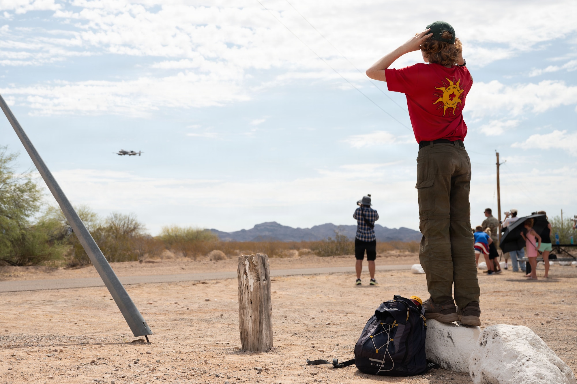 A scout from Scouts BSA watches an A-10C Thunderbolt II perform a low pass at the Barry M. Goldwater Range near Gila Bend, Arizona, June 25, 2026. Davis-Monthan Air Force Base invited community members to the final A-10 Range day to give back to the community that has supported the rescue and attack mission for over 50 years. (U.S. Air Force photo by Airman Najzee Kuzu)