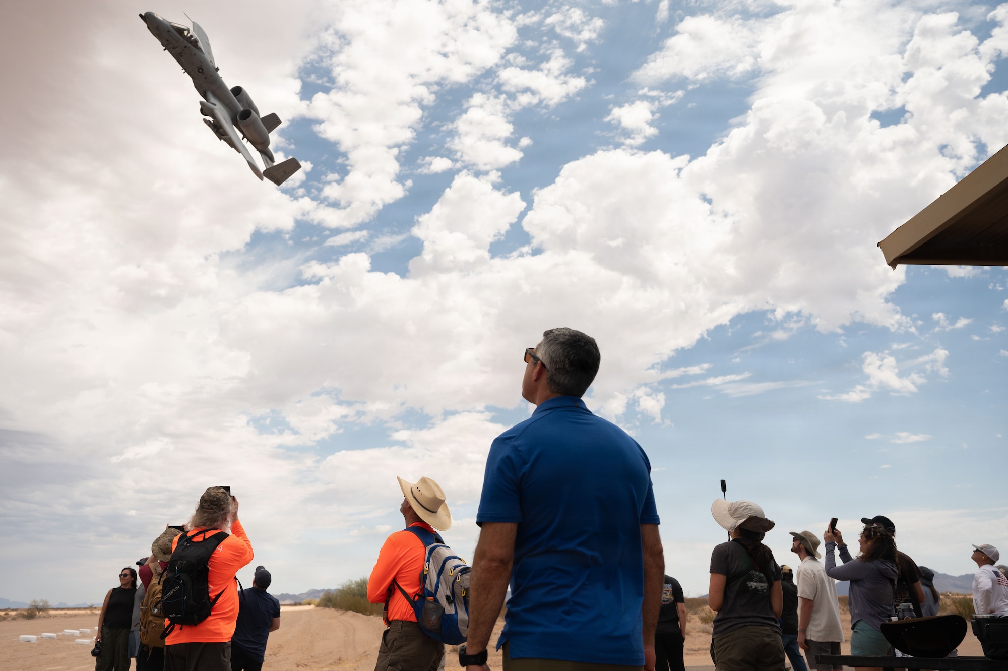U.S. Air Force Col. Jose Cabrera, 355th Wing Commander, watches an A-10C Thunderbolt II perform a show of force at the Barry M. Goldwater Range near Gila Bend, Arizona, June 25, 2026. Cabrera and other Davis-Monthan leadership came to support the installation's rescue and attack mission and to witness a display of air power. (U.S. Air Force photo by Airman Najzee Kuzu)