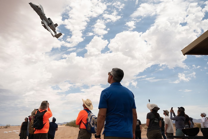 U.S. Air Force Col. Jose Cabrera, 355th Wing Commander, watches an A-10C Thunderbolt II perform a show of force at the Barry M. Goldwater Range near Gila Bend, Arizona, June 25, 2026. Cabrera and other Davis-Monthan leadership came to support the installation's rescue and attack mission and to witness a display of air power. (U.S. Air Force photo by Airman Najzee Kuzu)