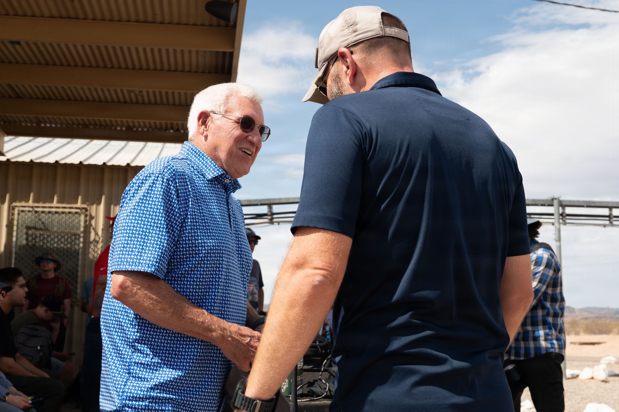 Retired U.S. Air Force Lt. Gen. Glen “Wally” Moorhead shakes hands with Anthony J. “A.J.” Mottola Jr., 56th Range Management Office public affairs officer at the Barry M. Goldwater Range near Gila Bend, Arizona, June 25, 2026. Moorhead was one of the first A-10C Thunderbolt II pilots at  Davis-Monthan Air Force Base. (U.S. Air Force photo by Airman Najzee Kuzu)