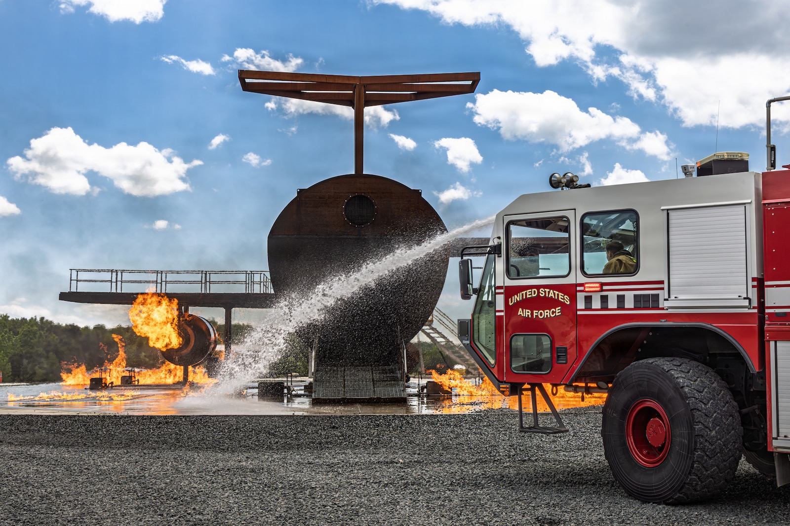 Photo of fire fighters from the Vermont National Guard's 158th Fighter Wing engage an aircraft fire during an exercise in New London, North Carolina.