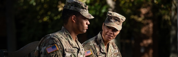 Building Resilient Teams Through Engage Intervention Training. Two soldiers sitting outdoors together.