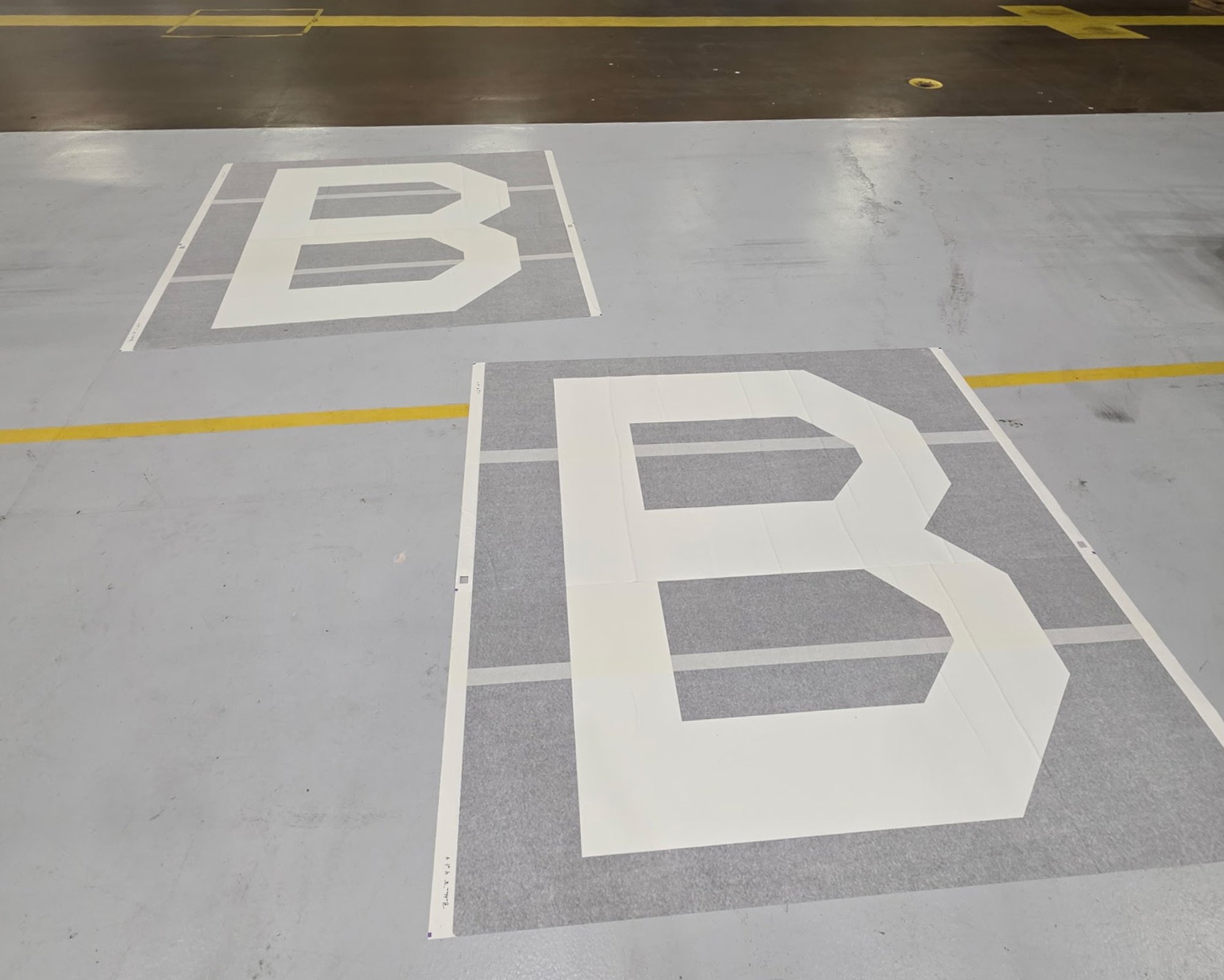 Two Square B vinyl appliques lay on the ground