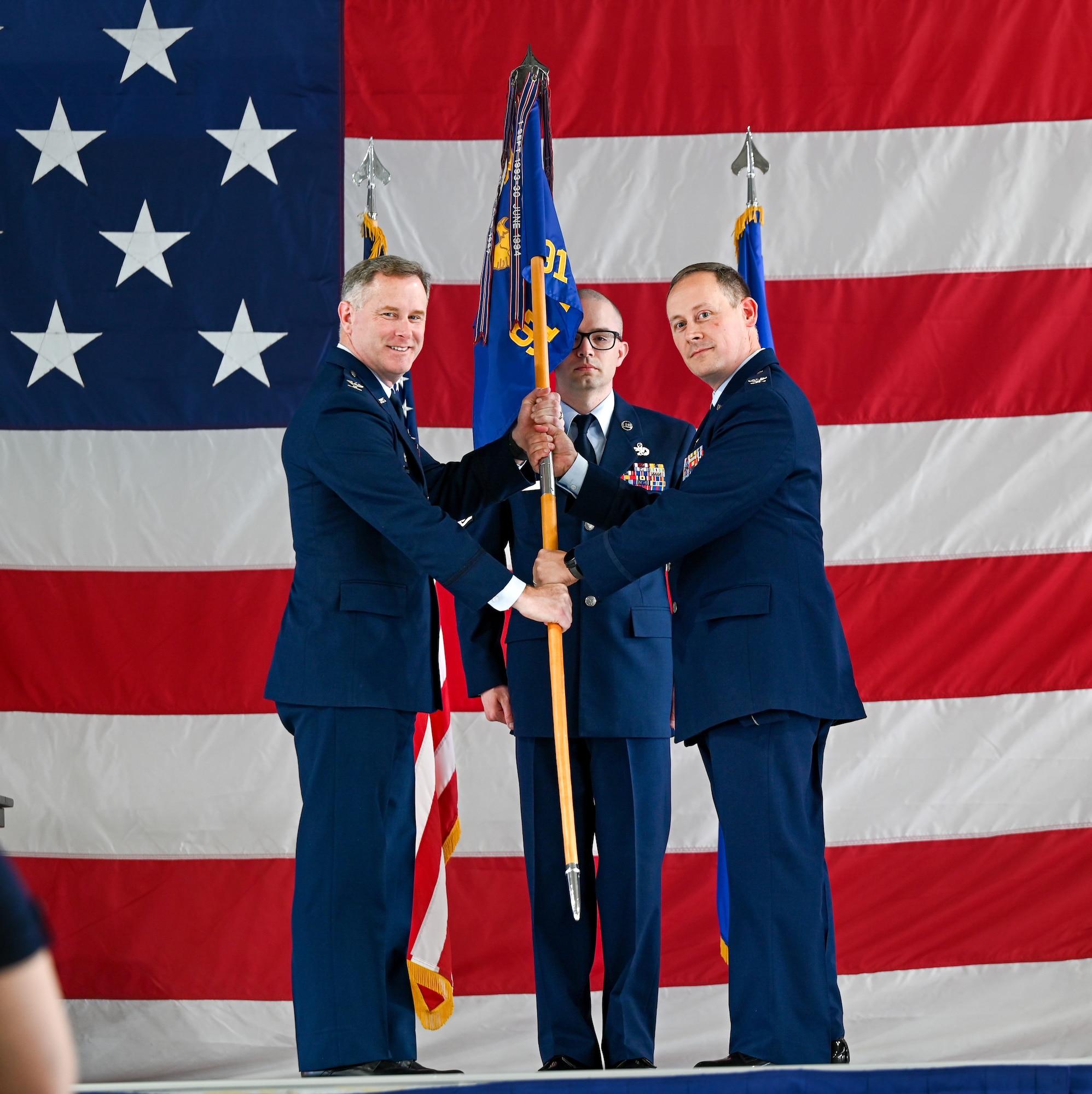 U.S. Air Force Col. Adam T. Rector, incoming 91st Maintenance Group (MXG) commander (right), accepts the guidon from U.S. Air Force Col. Jimmy Schlabach, 91st Missile Wing commander (left), during the 91st MXG change of command ceremony at Minot Air Force Base, North Dakota, June 5, 2026. Following three years as Air Force Operational Test and Evaluation Center Detachment 3 commander, Rector assumed command of the 91st MXG, bringing his experience and leadership to an organization critical to sustaining the wing’s readiness and strategic deterrence mission.