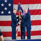 U.S. Air Force Col. Joseph Edington 91st Maintenance Group (MXG) commander, (right) hands over the guidon to Col. Jimmy Schlabach, 91st Missile Wing commander (left), during the 91st MXG change of command ceremony at Minot Air Force Base, North Dakota, June 5, 2026. Edington passed the guidon to Schlabach, who then presented it to the incoming commander, signifying the transfer of authority and responsibility within the 91st MXG.