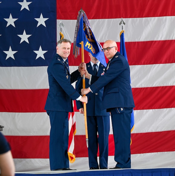 U.S. Air Force Col. Joseph Edington 91st Maintenance Group (MXG) commander, (right) hands over the guidon to Col. Jimmy Schlabach, 91st Missile Wing commander (left), during the 91st MXG change of command ceremony at Minot Air Force Base, North Dakota, June 5, 2026. Edington passed the guidon to Schlabach, who then presented it to the incoming commander, signifying the transfer of authority and responsibility within the 91st MXG.