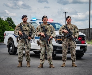 From left: U.S. Air Force Staff Sgt. Joe Jimenez, 2nd Security Forces Squadron certified law enforcement officer, Staff Sgt. Danny Gonzalez, 2nd SFS response force lead, and Staff Sgt. Martin Schortye, 2nd SFS base defense operation center controller, pose for a photo at Barksdale Air Force Base, Louisiana, June 5, 2026. The three defenders received the American Red Cross Lifesaving Award and an Air and Space Achievement Medal for their lifesaving actions following a motorcycle accident. (U.S. Air Force photo by Senior Airman Laiken King) (Portions of this image have been blurred for operational security.)