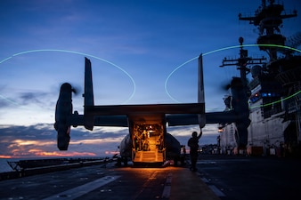 A U.S. Marine Corps MV-22B Osprey, assigned to Marine Medium Tiltrotor Squadron (VMM) 163 (Reinforced), 11th Marine Expeditionary Unit (MEU), sits on the flight deck of Wasp-class amphibious assault ship USS Boxer (LHD 4) during flight quarters, June 21, 2026.