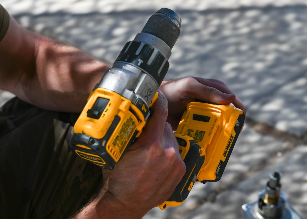 A U.S. Air Force Airman assigned to the 56th Civil Engineer Squadron prepares a cordless drill during a Prime Base Engineer Emergency Force training exercise.