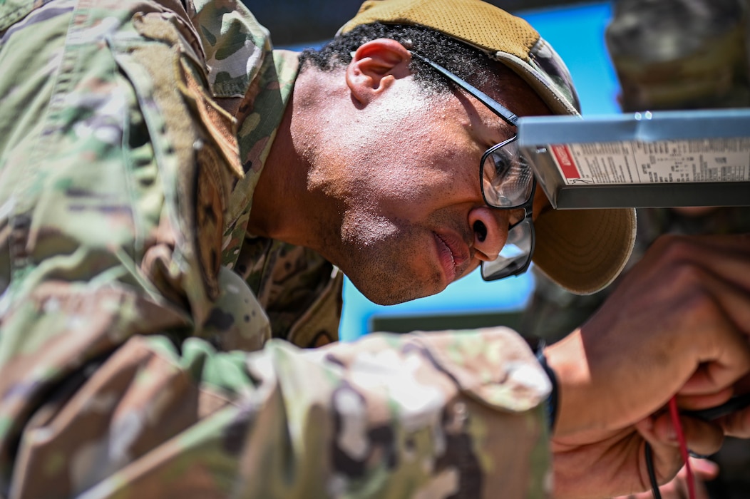 U.S. Air Force Staff Sgt. Trenton White, 56th Civil Engineer Squadron heating, ventilation, air conditioning and refrigeration supervisor, troubleshoots electrical equipment during a Prime Base Engineer Emergency Force training exercise.
