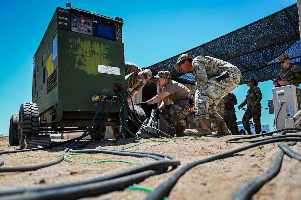 U.S. Air Force Airmen assigned to the 56th Civil Engineer Squadron work together to establish a stable source of electricity during a Prime Base Engineer Emergency Force exercise.