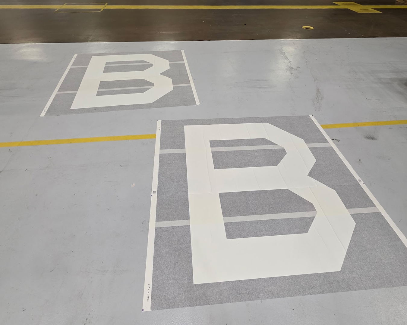 Two Square B vinyl appliques lay on the ground