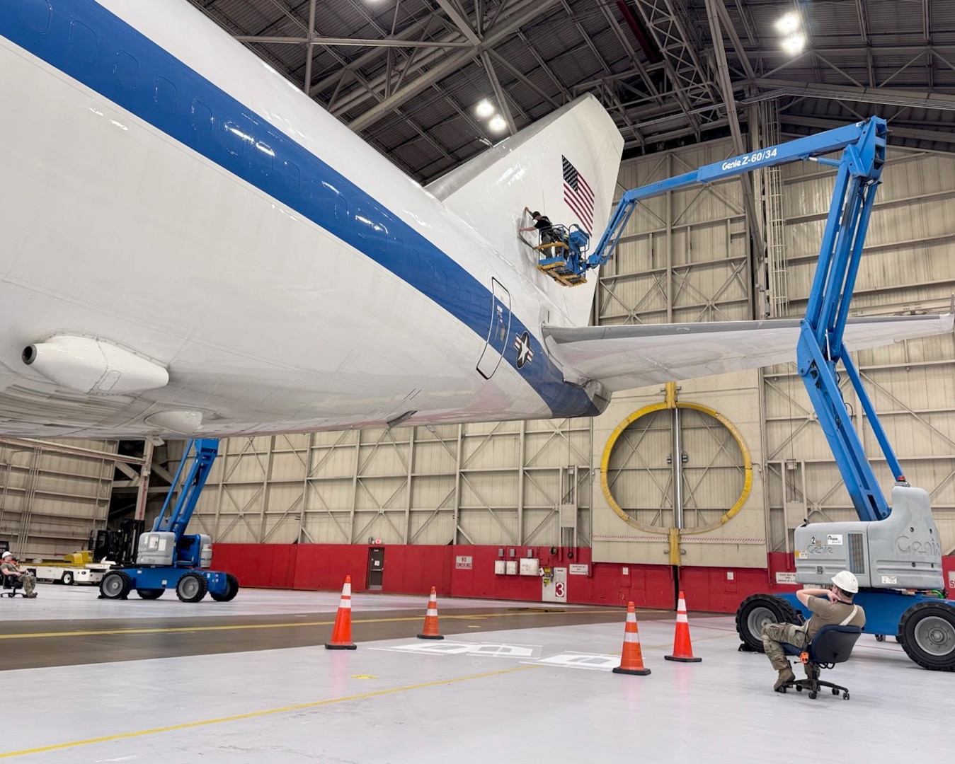 A team comprised of Airmen and civilians assigned to the 95th Maintenance Group apply a Square B vinyl applique