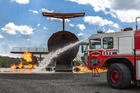 Photo of fire fighters from the Vermont National Guard's 158th Fighter Wing engage an aircraft fire during an exercise in New London, North Carolina.