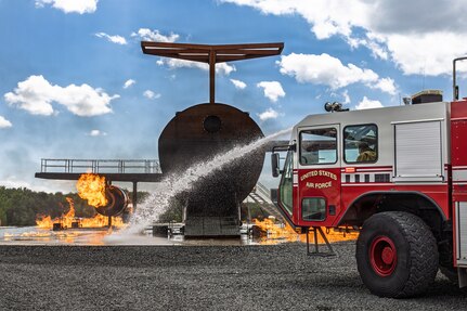 Photo of fire fighters from the Vermont National Guard's 158th Fighter Wing engage an aircraft fire during an exercise in New London, North Carolina.
