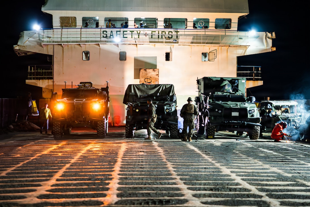 From left, a Navy-Marine Expeditionary Ship Interdiction System Leader Vehicle, a NMESIS, and a Mobile Command Vehicle, all assigned to 3rd Littoral Combat Team, 3rd Marine Littoral Regiment, 3rd Marine Division, are loaded on a Philippine surface connector during KAMANDAG 10 at Davila, Philippines, June 20, 2026.