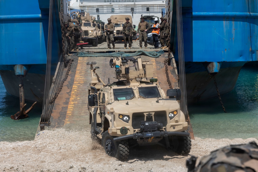 U.S. Marines assigned to 3rd Littoral Anti-Air Battalion, 3rd Marine Littoral Regiment, 3rd Marine Division, drive a Marine Air Defense Integrated System off a Philippine surface connector in support of maritime key terrain security operations during KAMANDAG 10 at Calayan, Philippines, June 22, 2026.