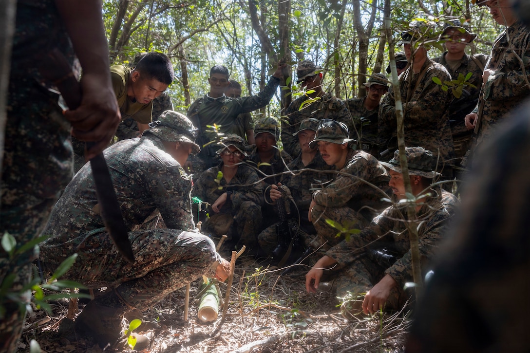 U.S. Marines assigned to 3rd Littoral Combat Team, 3rd Marine Littoral Regiment, 3rd Marine Division, learn trap making during a jungle survival class hosted by Philippine marines assigned to 3rd Marine Brigade, during KAMANDAG 10 at Paredes Air Station, Philippines, June 18, 2026.