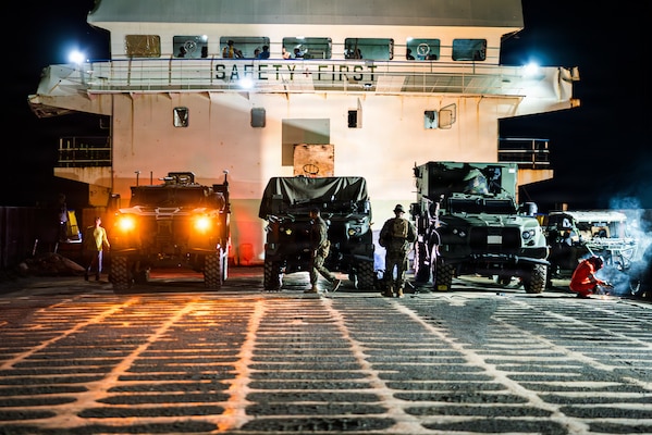 From left, a Navy-Marine Expeditionary Ship Interdiction System Leader Vehicle, a NMESIS, and a Mobile Command Vehicle, all assigned to 3rd Littoral Combat Team, 3rd Marine Littoral Regiment, 3rd Marine Division, are loaded on a Philippine surface connector during KAMANDAG 10 at Davila, Philippines, June 20, 2026.