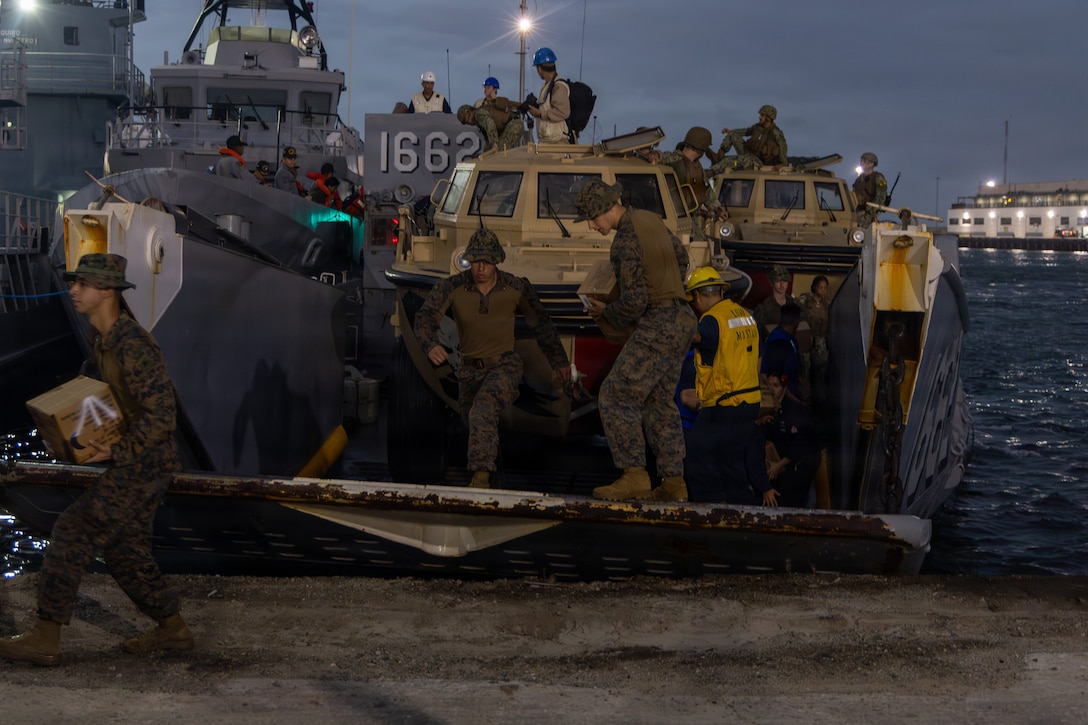 U.S. Marines with Littoral Combat Force-24, and U.S. Sailors with San Antonio-class amphibious transport dock USS Fort Lauderdale (LPD 28), offload disaster assistance supplies from a Landing Craft, Utility at La Guaira port, Venezuela, June 27, 2026. At the direction of U.S. Southern Command, assigned U.S. military forces are supporting Department of State-led U.S. disaster assistance to the people of Venezuela in the aftermath of the June 24, 2026, earthquakes. (U.S. Marine Corps photo)