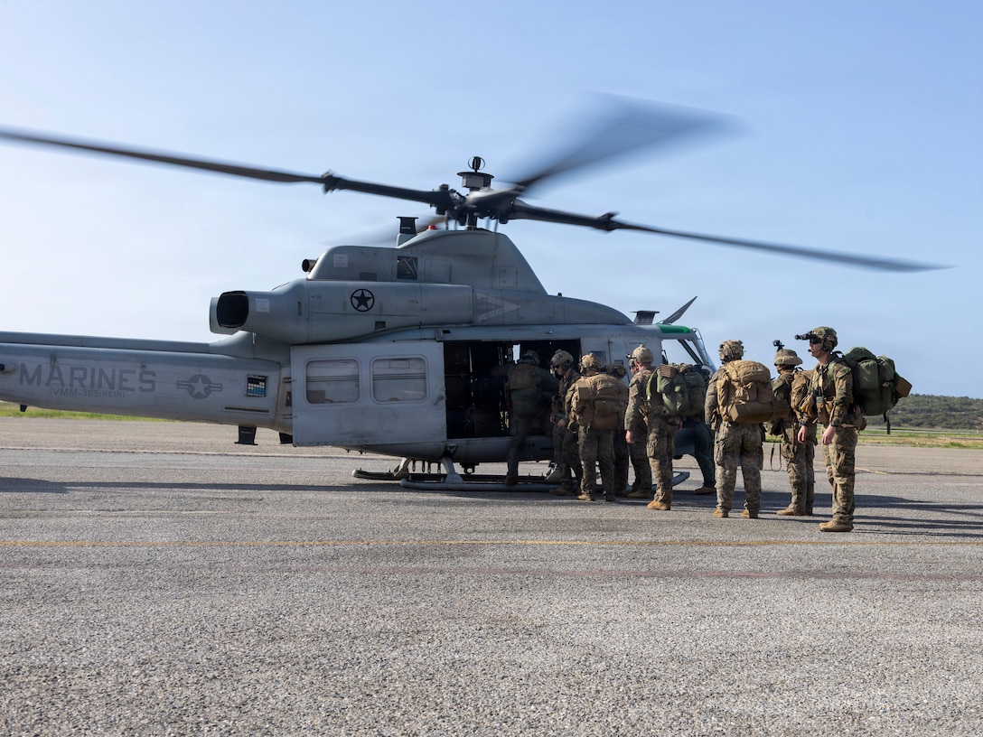 U.S. Marine Corps Maritime Raid Force with Littoral Combat Force-24, prepare to board an UH-1Y Venom with Marine Medium Tiltrotor Squadron (VMM) 365 (Reinforced), LCF-24, on Aeropuerto Internacional Simon Bolivar de Maiquetia, Venezuela, June 27, 2026. At the direction of U.S. Southern Command, assigned U.S. military forces are supporting Department of State-led U.S. disaster assistance to the people of Venezuela in the aftermath of the June 24, 2026, earthquakes. (U.S. Marine Corps photo)