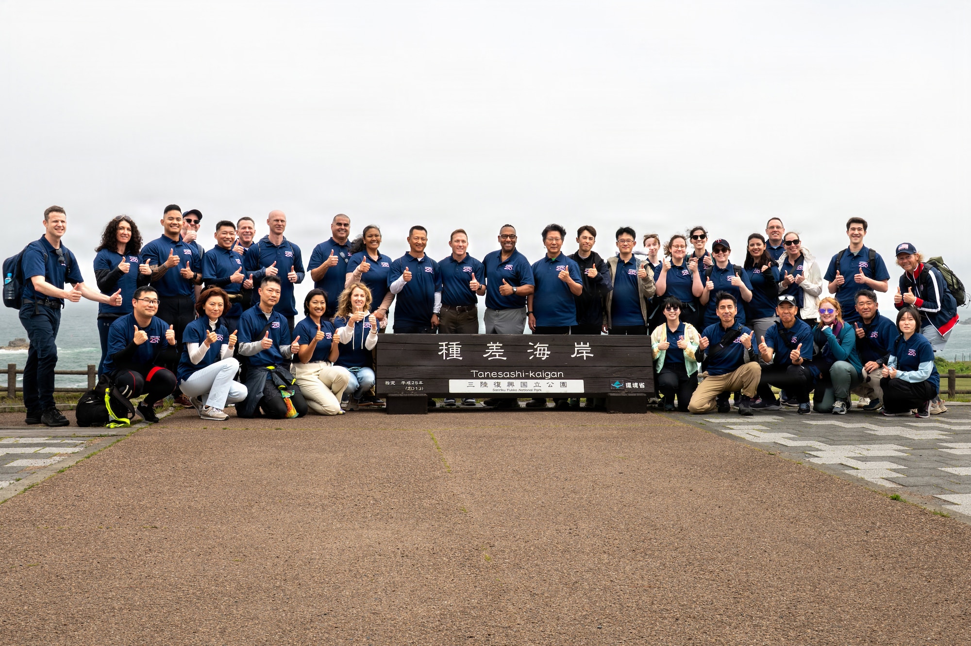 U.S. Embassy Deputy Chief of Mission, Aaron D. Snipe, poses for a group photo with 35th Fighter Wing leadership, Japan Air Self-Defense Forces leadership and local government officials at the Tanesashi Coast sign at Hachinohe, Japan, June 20, 2026.