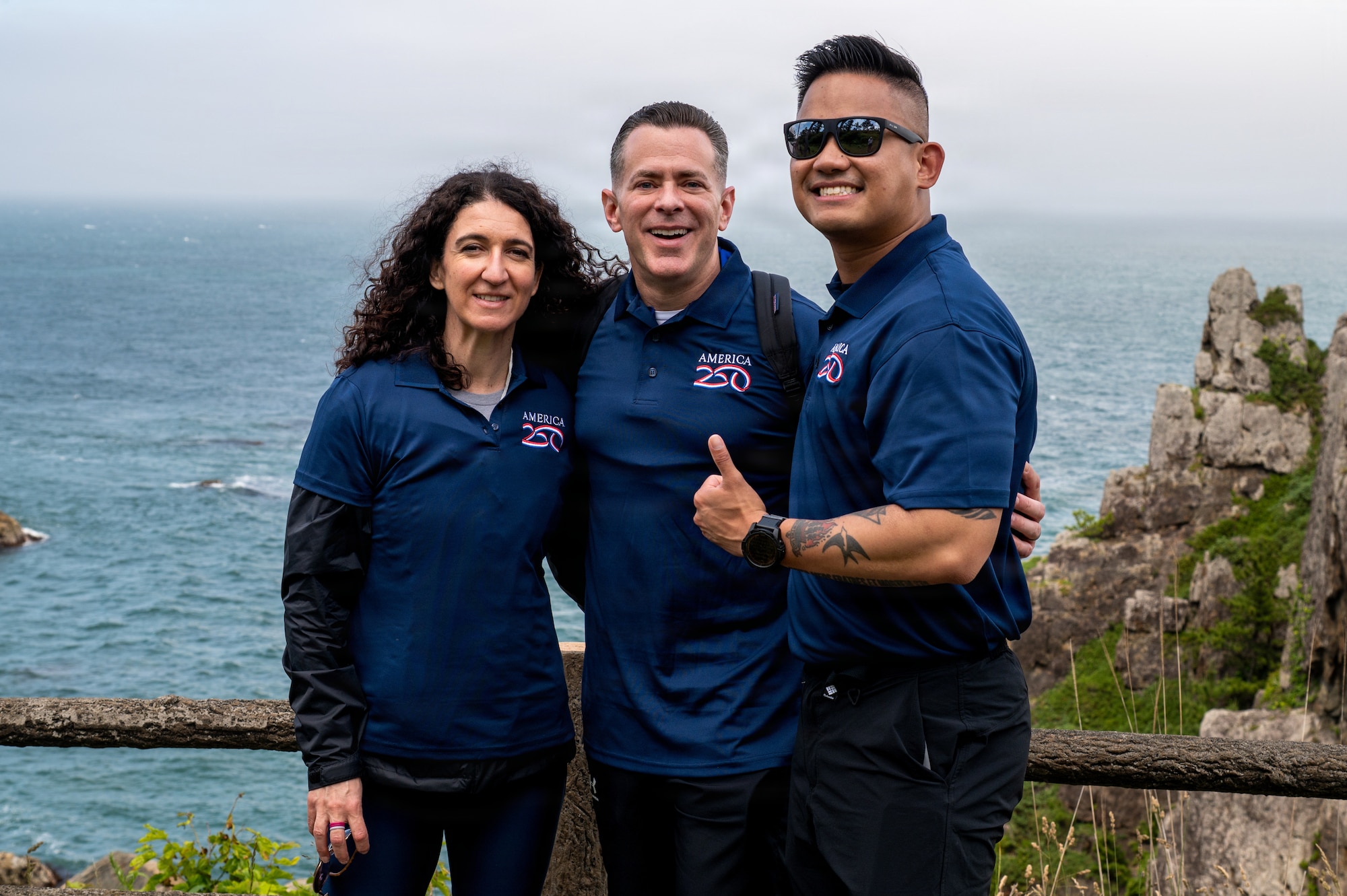 From left, Michela Kuhn, wife of U.S. Air Force Chief Master Sgt. Robert Kuhn, 35th Mission Support Group senior enlisted leader Capt. Vernon Nazareno, 35th Security Forces Squadron S3 operations officer, pose for a photo during a “Friendship Hike” at the Tanesashi Coast at Hachinohe, Japan, June 20, 2026.
