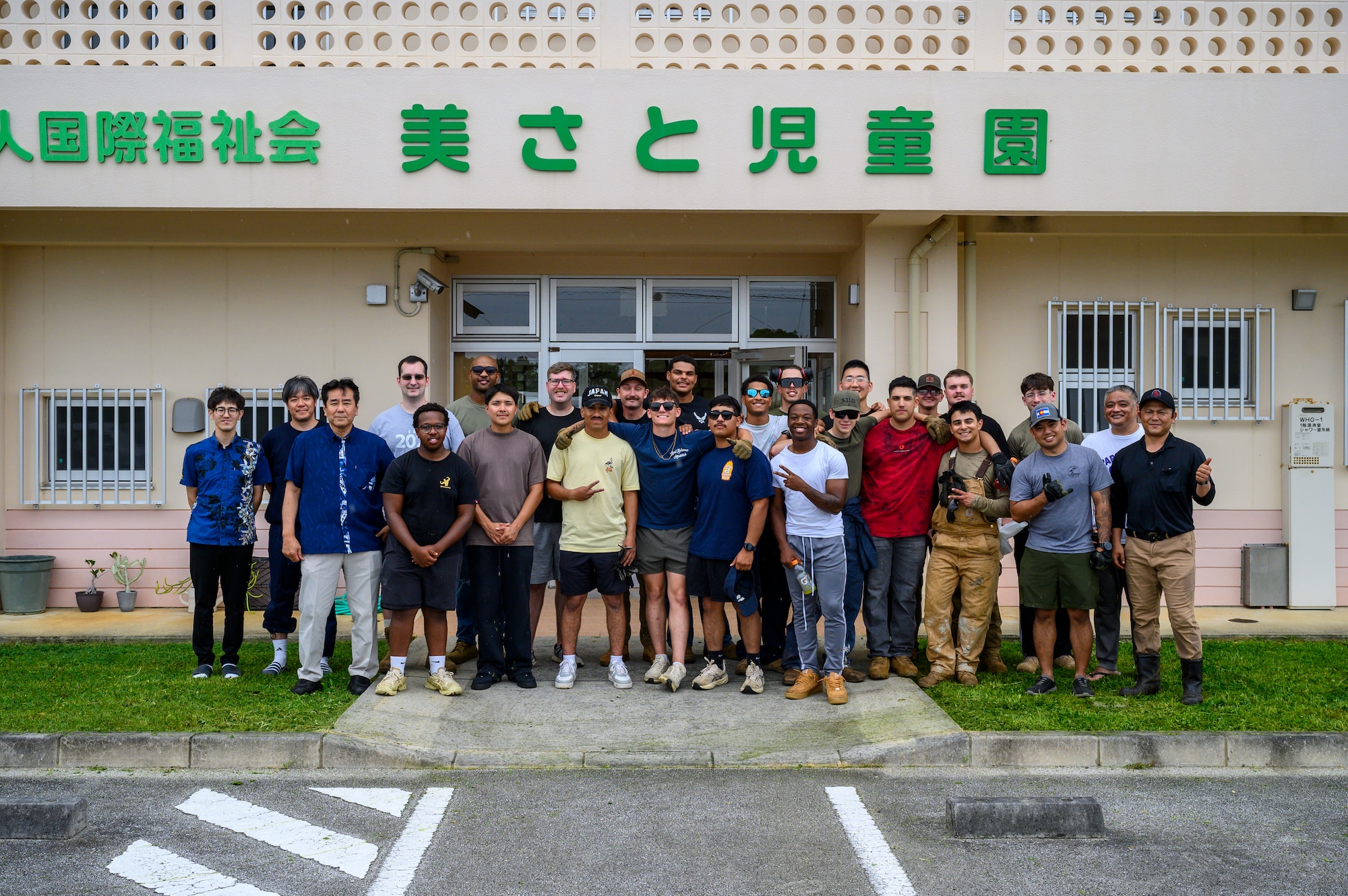 U.S. Air Force Airmen assigned to the 18th Civil Engineer Group and staff members from Misato Children’s Home pose for a group photo following a volunteer cleanup project in Okinawa, Japan, June 12, 2026. The event provided an opportunity for service members and community members to build lasting partnerships through volunteer service. (U.S. Air Force photo by Airman 1st Class Francisco Huerta)