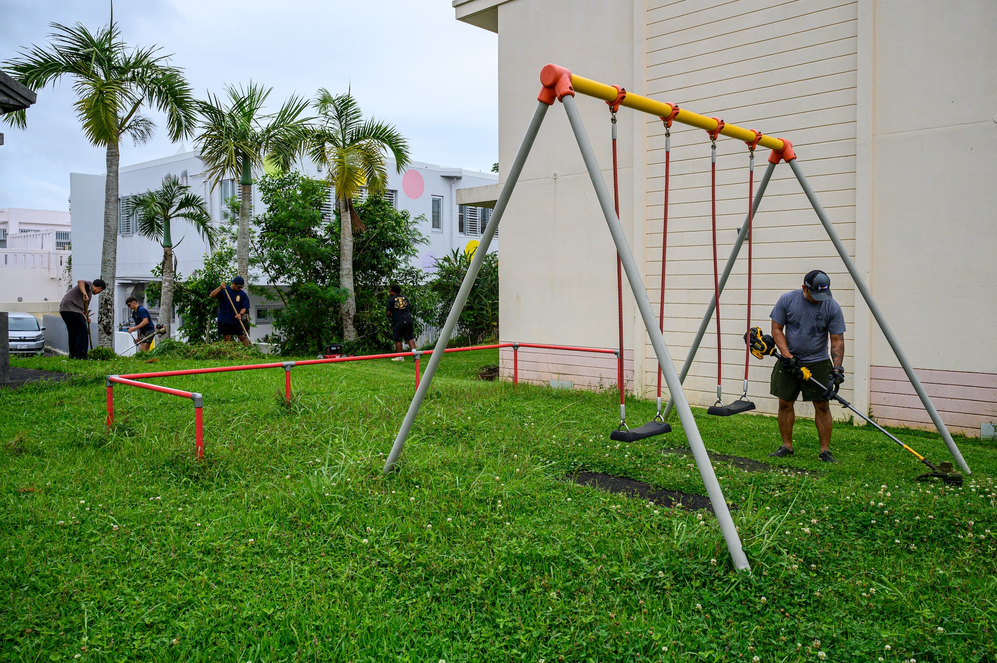 U.S. Air Force Airmen assigned to the 18th Civil Engineer Group cut grass around a playground at Misato Children’s Home in Okinawa, Japan, June 12, 2026. The cleanup effort helped create a safer outdoor environment for children while reinforcing Kadena Air Base's commitment to community engagement and partnership. (U.S. Air Force photo by Airman 1st Class Francisco Huerta)