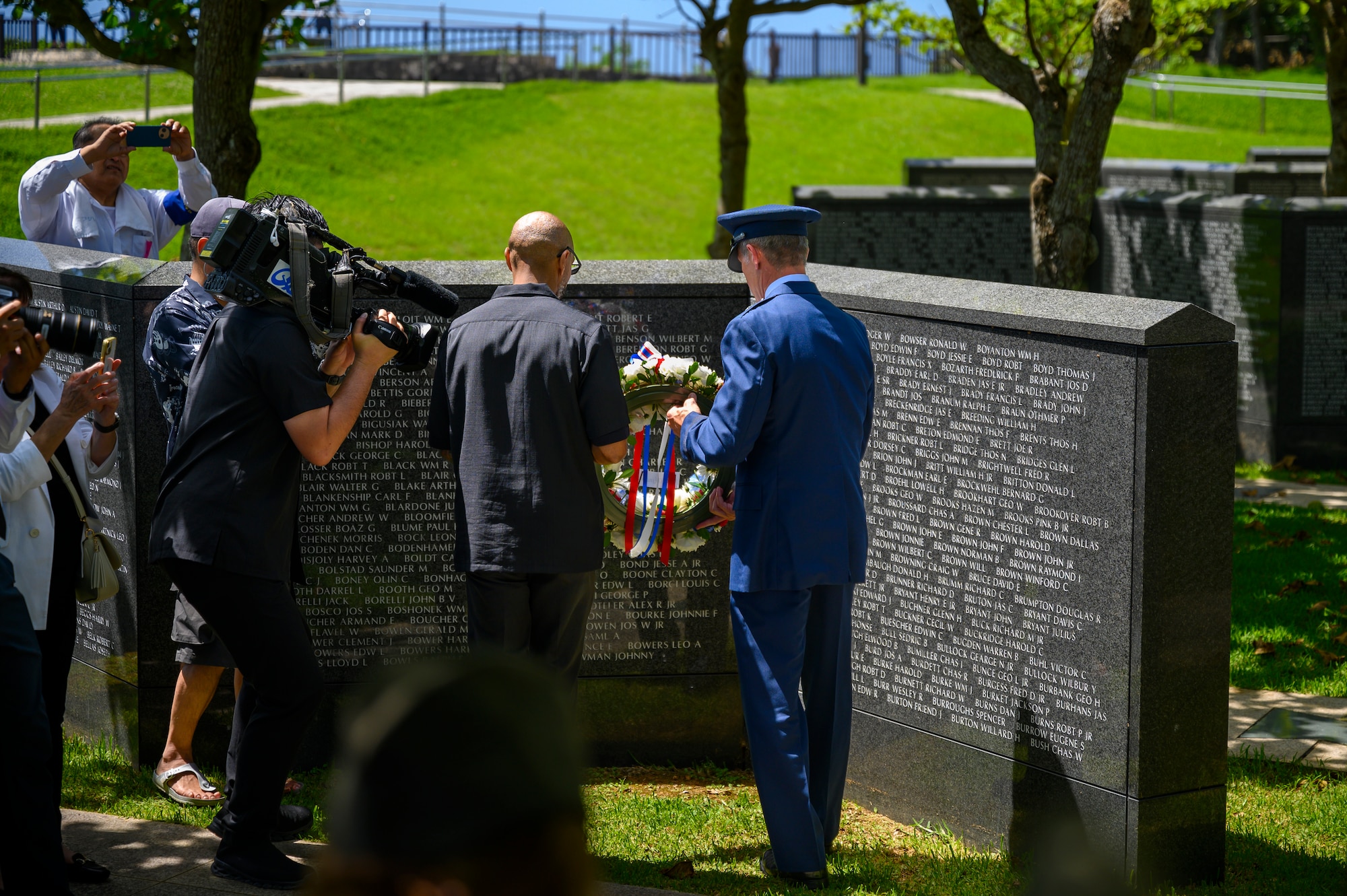 Henry Hughes, USO Okinawa area director, left, and U.S. Air Force Brig. Gen. John Gallemore, 18th Wing commander, place a ceremonial wreath at “The Cornerstone of Peace” during the Okinawa Memorial Day ceremony in Peace Memorial Park, Okinawa, Japan, June 23, 2026. The wreath-laying honored those who lost their lives during the Battle of Okinawa and served as a symbol of remembrance and reconciliation. (U.S. Air Force photo by Airman 1st Class Francisco Huerta)