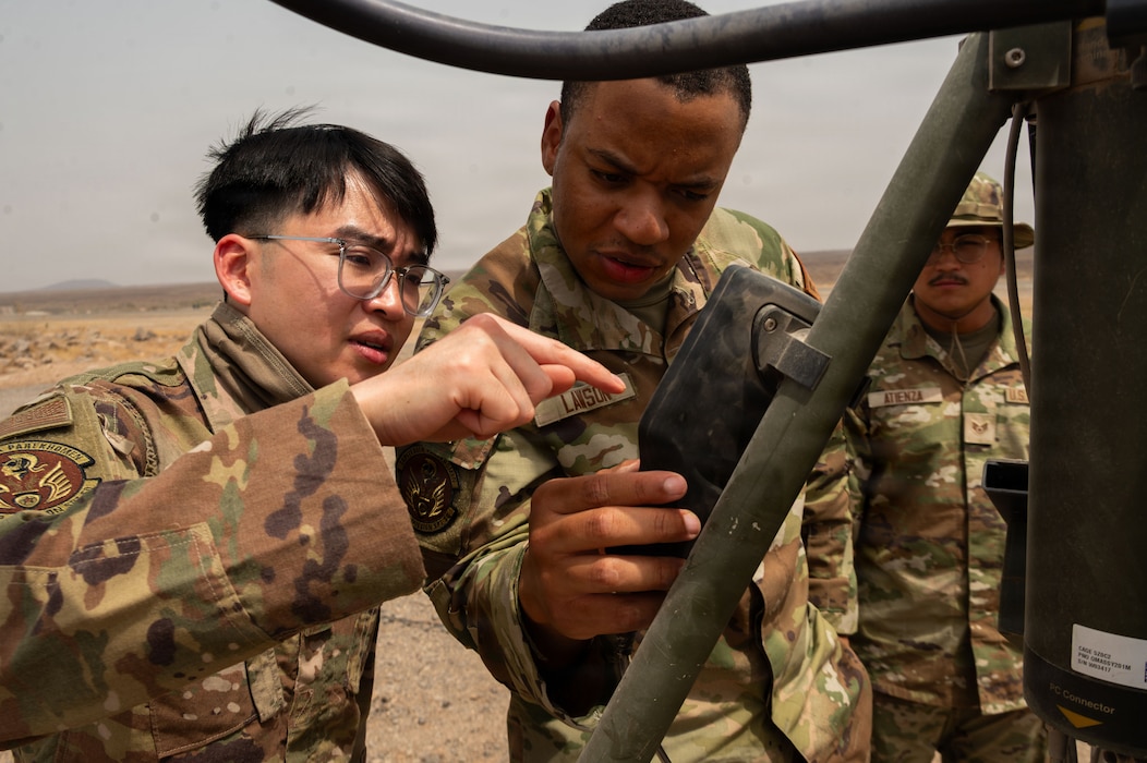 U.S. Air Force radar, airfield, and weather systems technicians assigned to the 776th Air Expeditionary Base Squadron review data on an AN/TMQ-53 Tactical Meteorological Observing System at Chabelley Airfield, Djibouti, May 19, 2026. The deployable weather station provides critical, real-time meteorological data to ensure safe flying operations. (U.S. Air Force photo by Senior Airman Luis Gomez)