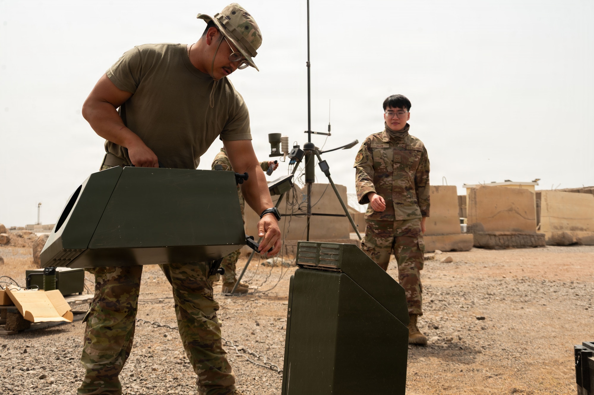 U.S. Air Force Staff Sgt. Jeremy Atienza, 776th Expeditionary Air Base Squadron radar, airfield, and weather systems technician, left, and Senior Airman Long Phan, 726th EMSS RAWS technician, right, assemble a AN/TMQ-53 Tactical Meteorological Observing System at Chabelley Airfield, Djibouti, May 19, 2026. The system is designed for rapid deployment and provides weather data such as wind speed, temperature, and precipitation. (U.S. Air Force photo by Senior Airman Luis Gomez)
