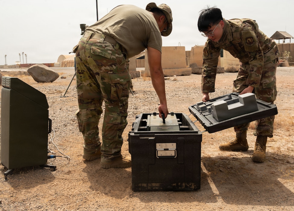 U.S. Air Force Staff Sgt. Jeremy Atienza, 776th Expeditionary Air Base Squadron radar, airfield, and weather systems technician, left, and Senior Airman Long Phan, 726th EMSS RAWS technician, right, unpacks a AN/TMQ-53 Tactical Meteorological Observing System at Chabelley Airfield, Djibouti, May 19, 2026. The system is designed for rapid deployment and provides weather data such as wind speed, temperature, and precipitation. (U.S. Air Force photo by Senior Airman Luis Gomez)