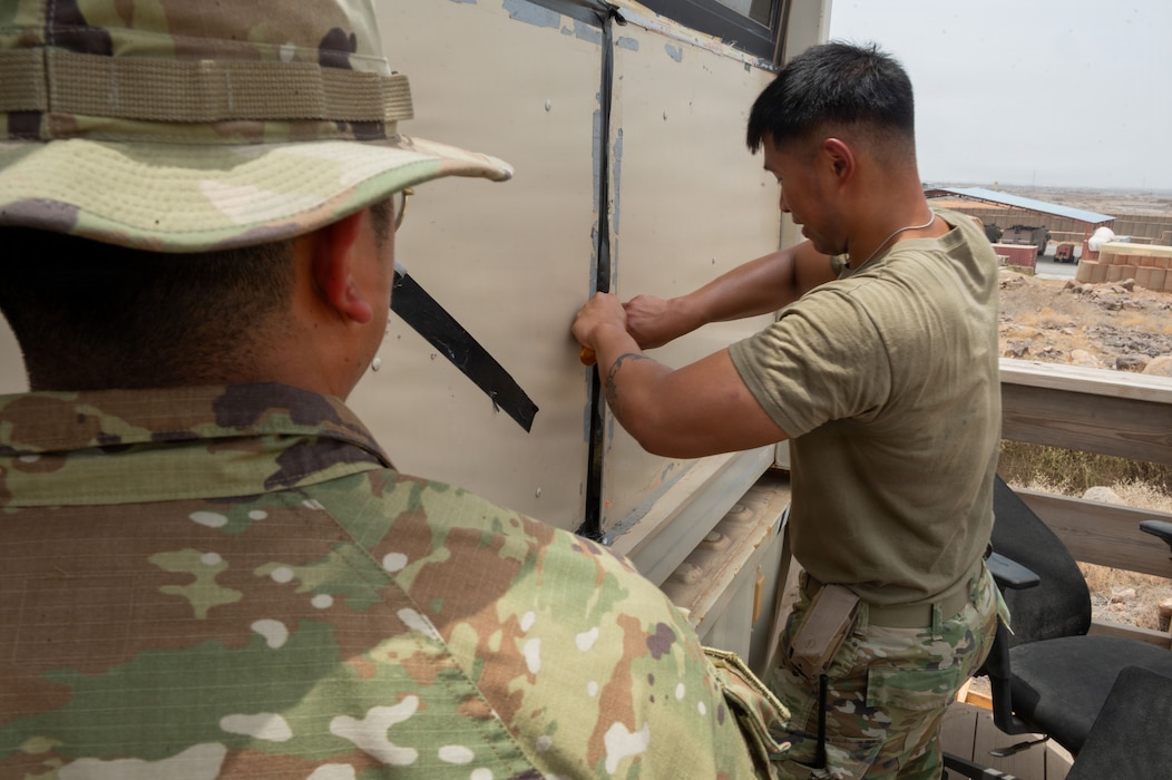 U.S. Air Force Senior Airman Physa Muon, 776th Expiditionary Air Base Squadron radar, airfield, and weather systems technician, inspects the internal wiring of a communications radio cabinet at Chabelley Airfield, Djibouti, May 19, 2026. These systems are essential for providing reliable air-to-ground and ground-to-ground communication between air traffic controllers and pilots operating in the region. (U.S. Air Force photo by Senior Airman Luis Gomez)