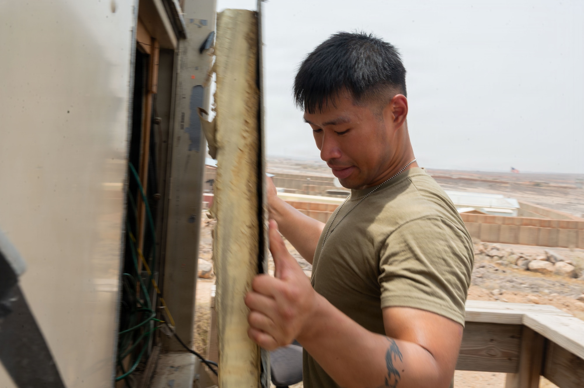 U.S. Air Force Senior Airman Physa Muon, 776th Expeditionary Air Base Squadron radar, airfield, and weather systems technician, inspects the internal wiring of a communications radio cabinet at Chabelley Airfield, Djibouti, May 19, 2026. These systems are essential for providing reliable air-to-ground and ground-to-ground communication between air traffic controllers and pilots operating in the region. (U.S. Air Force photo by Senior Airman Luis Gomez)