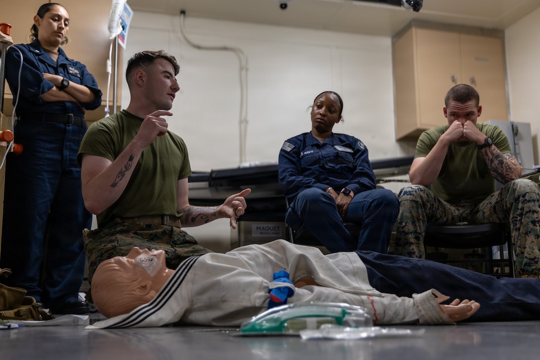 A U.S. Navy Corpsman with the Littoral Combat Force-24, center left, gives a tactical combat casualty care class aboard the San Antonio-class amphibious transport dock USS Fort Lauderdale (LPD 28) while underway in the Caribbean Sea, May 19, 2026. U.S. military forces are deployed to the U.S. Southern Command area of responsibility in support of Operation SOUHTERN SPEAR, Department of War-directed operations, and the president’s priorities to disrupt illicit drug trafficking, deter malign actors and protect the homeland through continuous presence. (U.S. Marine Corps photo)

(This photo was altered using Adobe Photoshop to blur names for operational security)
