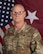 Soldier in front of flag.