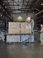 Preparing the Forward Deployable Preventive Medicine Unit (FDPMU) for shipment, members of the Expeditionary Medical Logistics directorate securely stow it prior to transport. The FDPMU provides rapidly deployable, portable, flexible and sustainable force health protection services to forward deployed elements of the Navy and Marine Corps through the advent of state-of-the-art detection and diagnostic equipment, and real-time analytical capabilities.