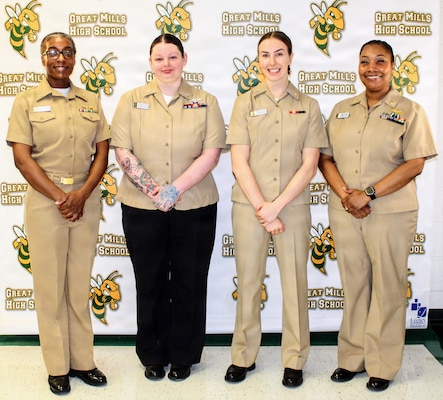 Members of the Navy Medicine Readiness and Training Command (NMRTC) Patuxent River medical and dental team pose for a photo at Great Mills High School. From left, Lt. Cmdr. Stephanie Green, Hospital Corpsman 3rd Class Rebecca Osgood, Lt. Natalie Grose, and Capt. Teresita Alston visited the school's Career Center to host a special session for students exploring futures in healthcare. The team discussed their personal career journeys and the diverse pathways into Navy Medicine and ended with an engaging interactive session.