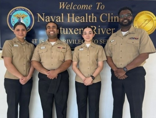 Sailors assigned to Navy Medicine Readiness and Training Command (NMRTC) Patuxent River pose for a photo before presenting at the Spring Ridge Middle School Career Day. From left, Hospitalman Apprentice Elisa Medina-Moya, Hospitalman 2nd Class Luis Morales, Hospitalman Apprentice Kaitlyn Lewis, and Hospital Corpsman 1st Class Reginald Smalls delivered dynamic presentations on Tactical Combat Casualty Care (TCCC), and the roles of laboratory and pharmacy technicians in the Navy.