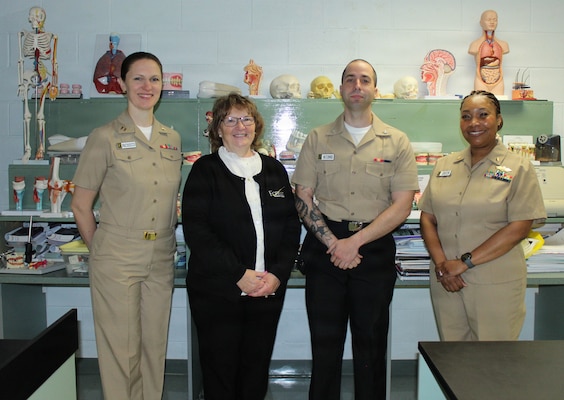 Members of the Navy Medicine Readiness and Training Command (NMRTC) Patuxent River dental team pose for a photo with Wendy J. Farrell, a dental assisting instructor at the Dr. James A. Forrest Career and Technology Center. From left, Lt. Kellie Pacheco, Farrell, Hospitalman 3rd Class Mitchell McGinnis, and Cmdr. Stephanie Green visited the school to speak with Dental Assisting II students about career pathways in Navy dentistry and share their personal experiences.