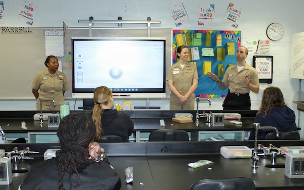 Hospitalman 3rd Class Mitchell McGinnis, assigned to Navy Medicine Readiness and Training Command (NMRTC) Patuxent River, shares his experiences with Dental Assisting II students at the Dr. James A. Forrest Career and Technology Center. McGinnis, alongside Navy dentists Cmdr. Stephanie Green (left) and Lt. Kellie Pacheco (center), explained the training involved in the military dental field and offered students a look at how military service translates to civilian credentials.