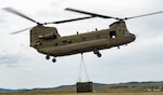 A CH-47 Chinook helicopter assigned to the 1st Battalion (General Support Aviation), 189th Aviation Regiment transports an MEP-806 power generator by sling load during a joint field training exercise at Fort Harrison, Montana, June 26, 2026. The mission validated a new operational capability between the Montana Army National Guard and the 219th Red Horse Squadron, strengthening the Montana National Guard's domestic operations capabilities through joint aviation and engineering training. Photo by Senior Master Sgt. Devin Doskey.