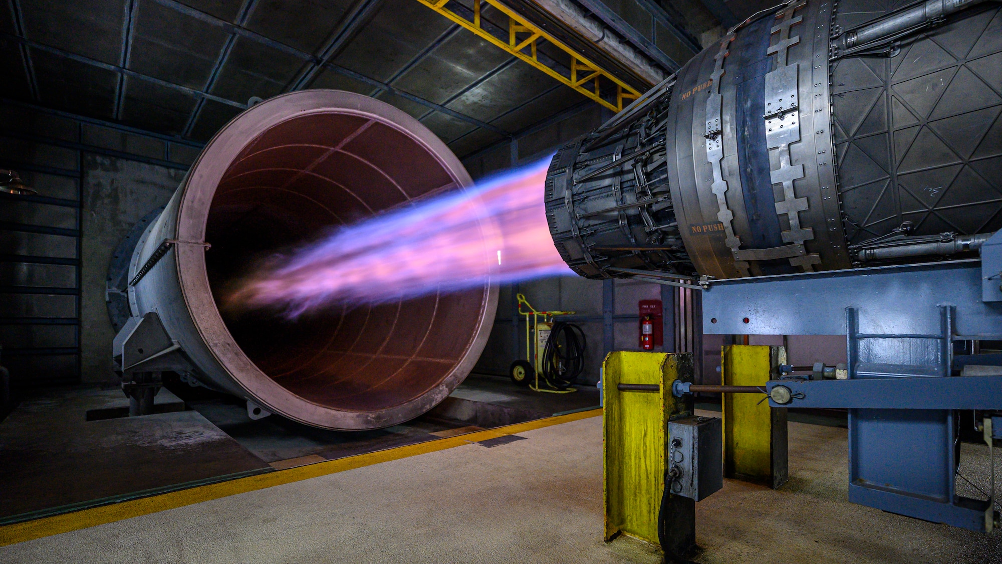 An F100-PW-220 engine from an F-15E Strike Eagle operates in afterburner during a routine engine test at Kadena Air Base, Japan, May 14, 2026. Airmen assigned to the 18th Component Maintenance Squadron conduct engine testing in a specialized test cell to verify engine performance and ensure all components function properly before returning the engine to service.  (U.S. Air Force photo by Airman 1st Class Francisco Huerta)