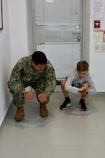 Hospital Corpsman Third Class Carlos Diaz-Martinez, assigned to U.S. Naval Hospital Rota, conducts a movement assessment on a Department of War Education Activity (DoWEA) student athlete during a sports physical rodeo at David Glasgow Farragut Middle High School, Naval Station Rota, Spain, June 02,2026. During the event, U.S. Naval Hospital Rota staff completed more than 169 sports physicals, helping improve access to care for military families and ensuring students meet participation requirements for the 2026–2027 school year. (U.S. Navy photo by Mr. Everett Lopez)