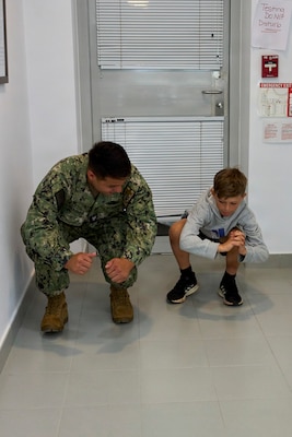 Hospital Corpsman Third Class Carlos Diaz-Martinez, assigned to U.S. Naval Hospital Rota, conducts a movement assessment on a Department of War Education Activity (DoWEA) student athlete during a sports physical rodeo at David Glasgow Farragut Middle High School, Naval Station Rota, Spain, June 02,2026. During the event, U.S. Naval Hospital Rota staff completed more than 169 sports physicals, helping improve access to care for military families and ensuring students meet participation requirements for the 2026–2027 school year. (U.S. Navy photo by Mr. Everett Lopez)