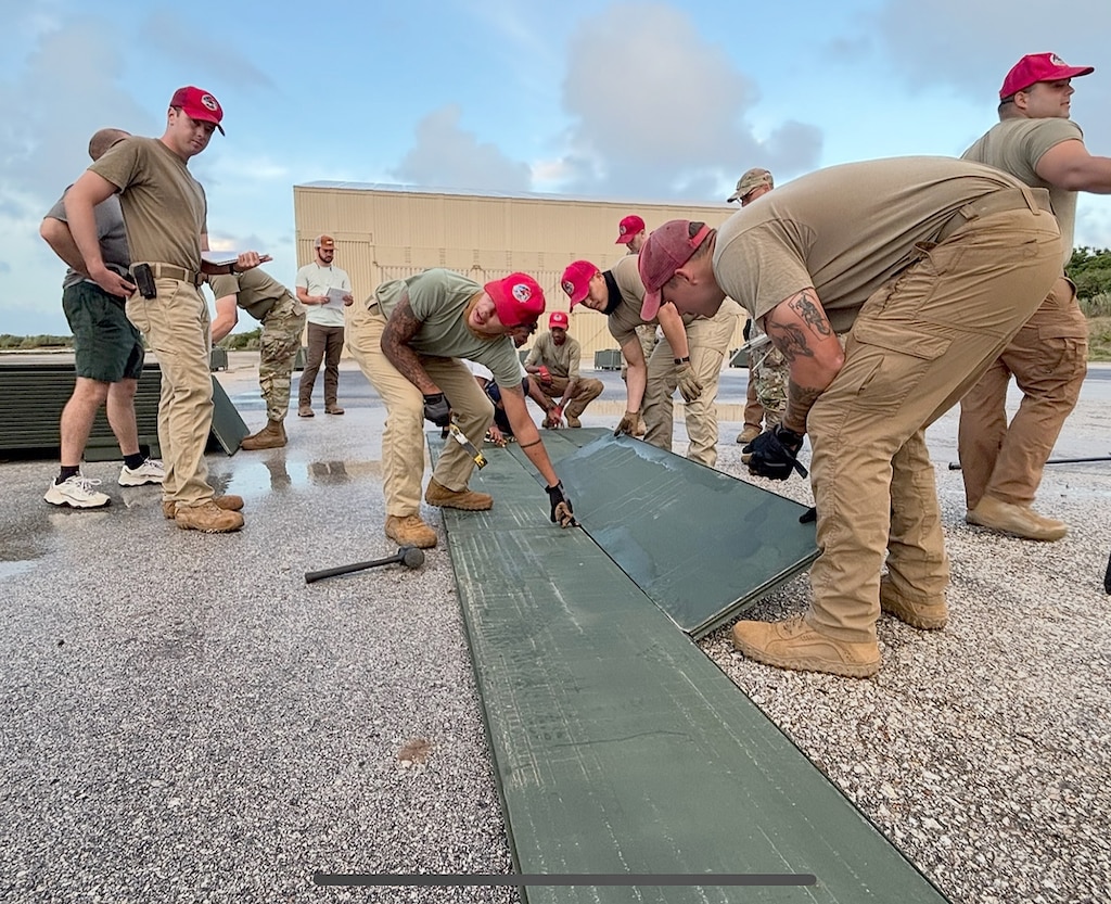 U.S. Air Force personnel conduct a demonstration of deploying the Airfield Mat Lightweight System recently in Guam. The system, designed by ERDC, is lighter than previous systems aimed at quickly establishing airfield capabilities in austere environments. (photo by Jeb Tingle)