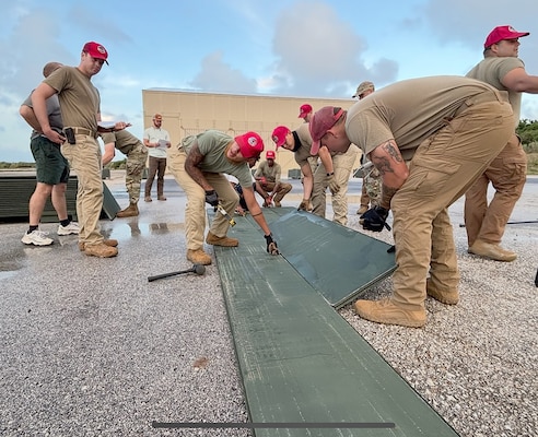 U.S. Air Force personnel conduct a demonstration of deploying the Airfield Mat Lightweight System recently in Guam. The system, designed by ERDC, is lighter than previous systems aimed at quickly establishing airfield capabilities in austere environments. (photo by Jeb Tingle)