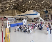 A crowd sits in front of an E-4B